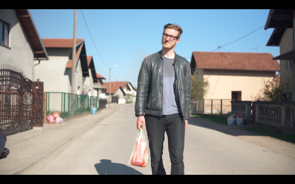 Ismar Badžić walking through a village in Bosnia